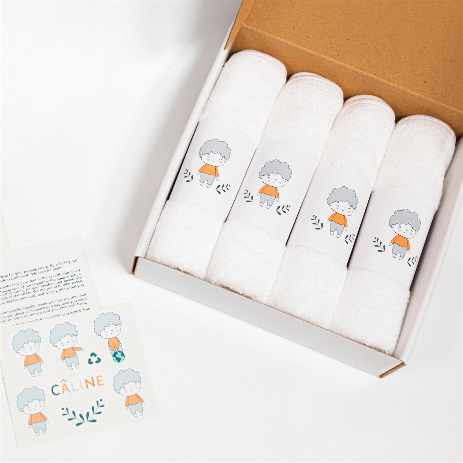 Open CÂLINE gift box with four rolled washcloths and thank-you card